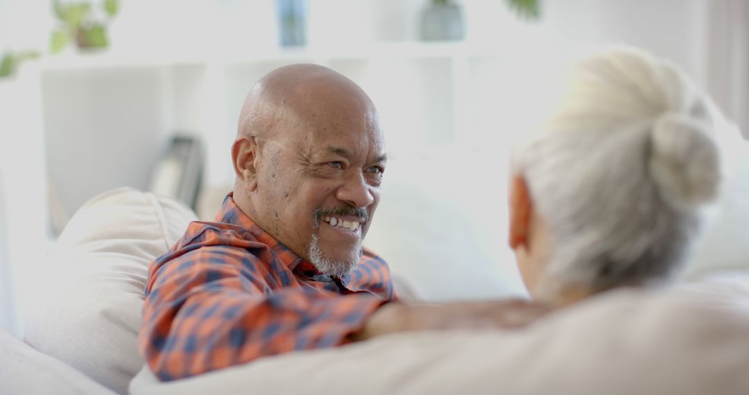 Senior Couple Relaxing and Smiling in Living Room