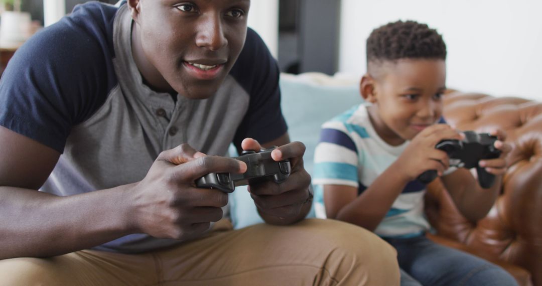 Father and Son Enjoying Video Game Together at Home - Free Images, Stock Photos and Pictures on Pikwizard.com