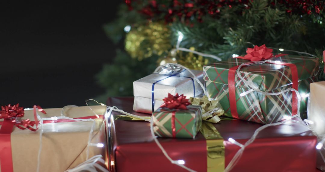 Colorful Wrapped Gifts Under Twinkling Christmas Tree