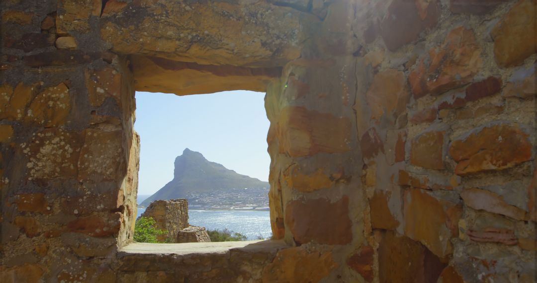 Scenic Coastline View through Rustic Stone Window Frame - Free Images, Stock Photos and Pictures on Pikwizard.com