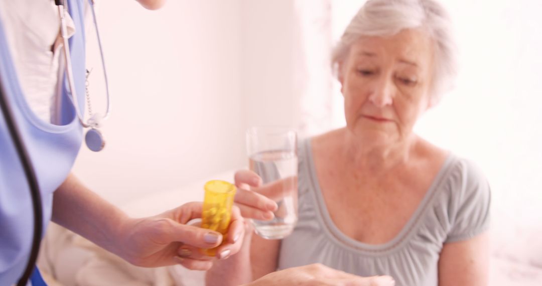 Nurse Assisting Elder Woman with Medication at Home - Free Images, Stock Photos and Pictures on Pikwizard.com