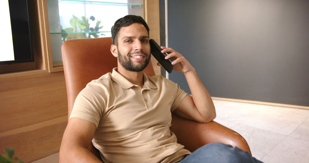 Smiling Professional Talking on Smartphone in Modern Office