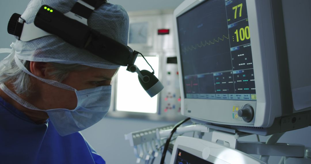 Surgeon Focusing During Surgery While Monitoring Vital Signals - Free Images, Stock Photos and Pictures on Pikwizard.com