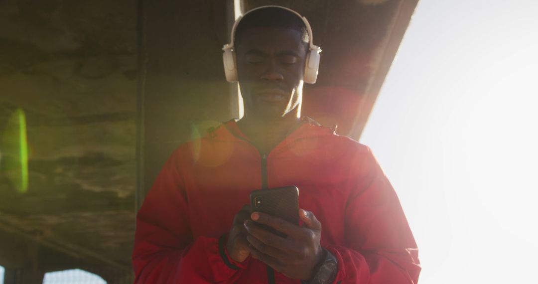 Focused African American Male Listening to Music on Smartphone - Free Images, Stock Photos and Pictures on Pikwizard.com