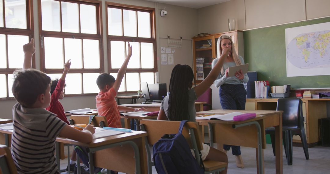 Students Raising Hands in Classroom with Teacher Holding Tablet - Free Images, Stock Photos and Pictures on Pikwizard.com