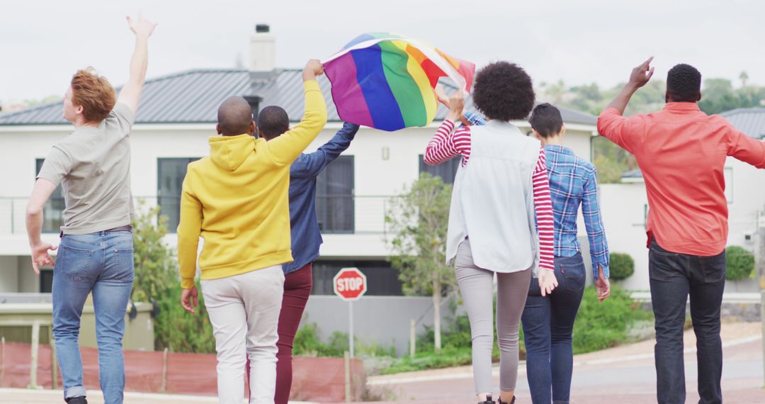 Back view of group of diverse male and female protesters walking with rainbow flag - Free Images, Stock Photos and Pictures on Pikwizard.com