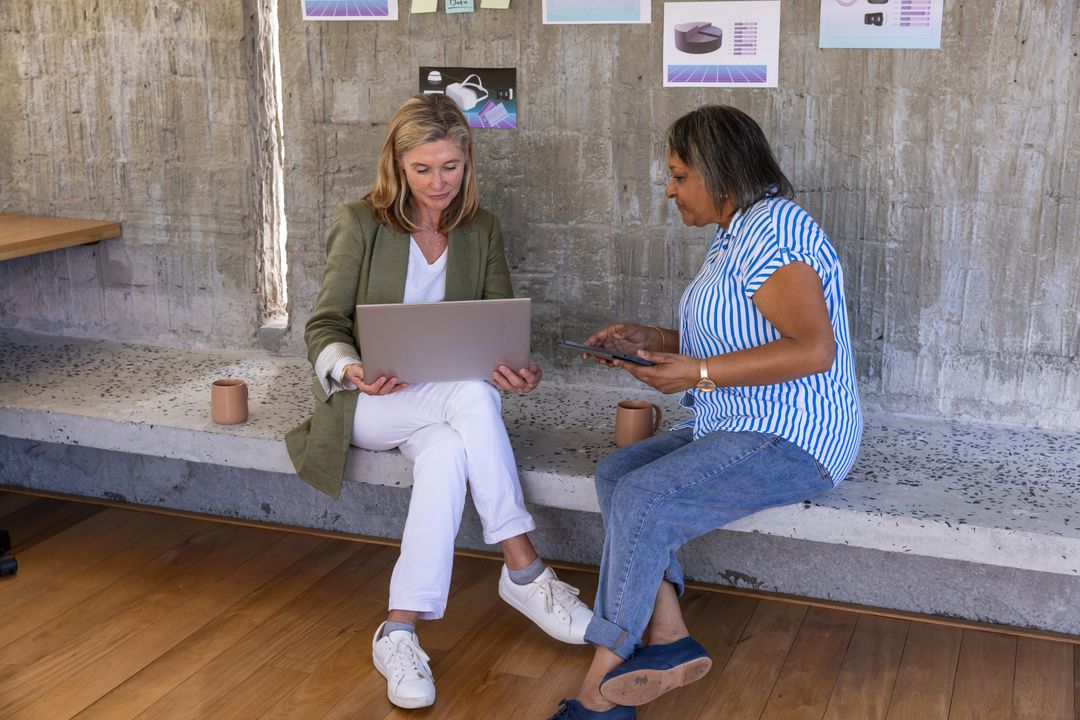 Senior Women Collaborating in Modern Workspace