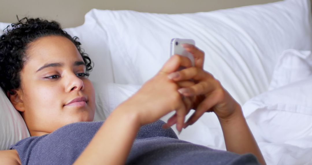 Relaxed Woman Lying in Bed Using Smartphone at Home - Free Images, Stock Photos and Pictures on Pikwizard.com