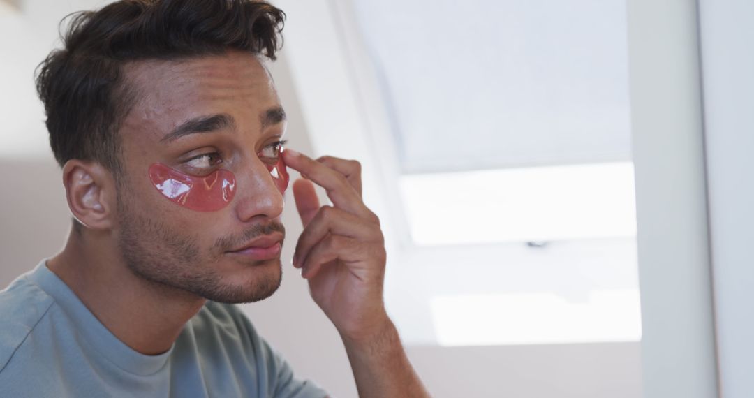 Man Applying Under Eye Masks for Skincare Routine - Free Images, Stock Photos and Pictures on Pikwizard.com