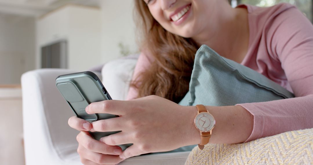 Woman Smiling While Using Smartphone at Home - Free Images, Stock Photos and Pictures on Pikwizard.com