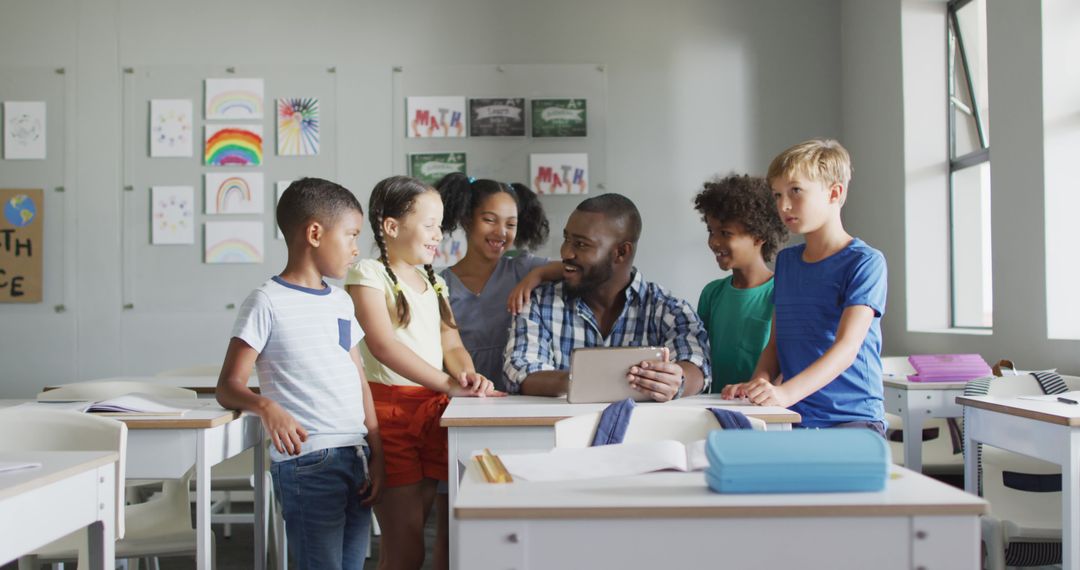 Image of happy african american male teacher and class of diverse pupils working on tablet - Free Images, Stock Photos and Pictures on Pikwizard.com