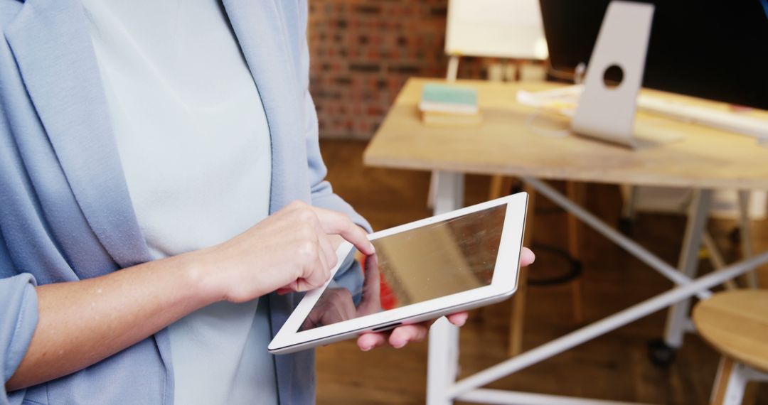 Person Using Tablet in Modern Office Space - Free Images, Stock Photos and Pictures on Pikwizard.com