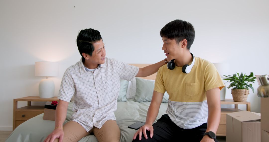 Father and Son Bonding While Unpacking in Bedroom