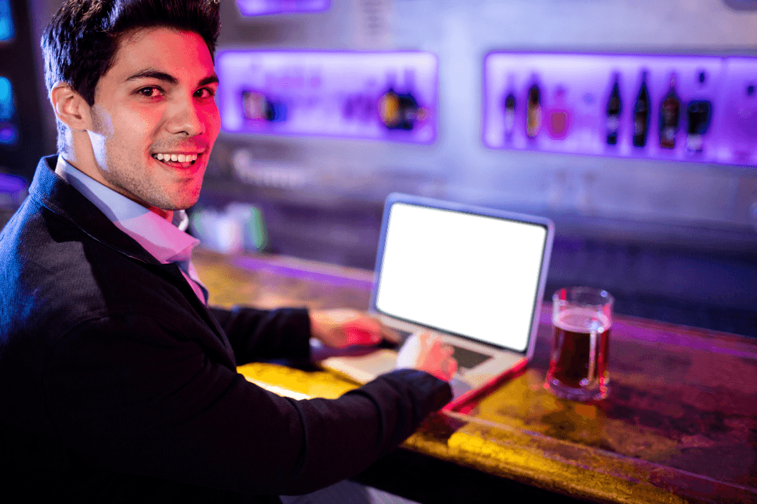 Smiling Businessman Using Transparent Laptop at Bar Counter