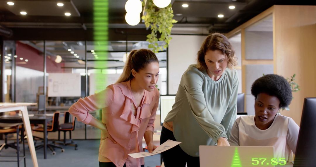 Diverse Team Analyzing Data on Computer in Modern Office Environment