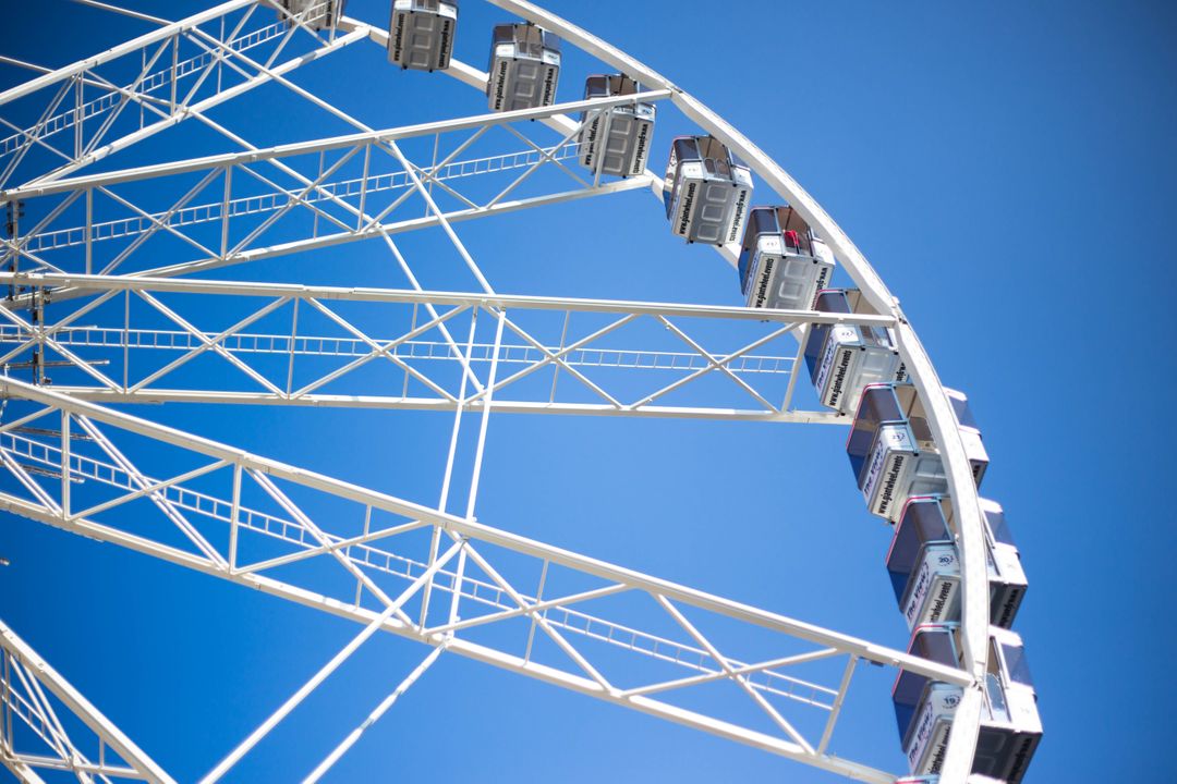 Close-Up View of Ferris Wheel Against Clear Blue Sky - Free Images, Stock Photos and Pictures on Pikwizard.com