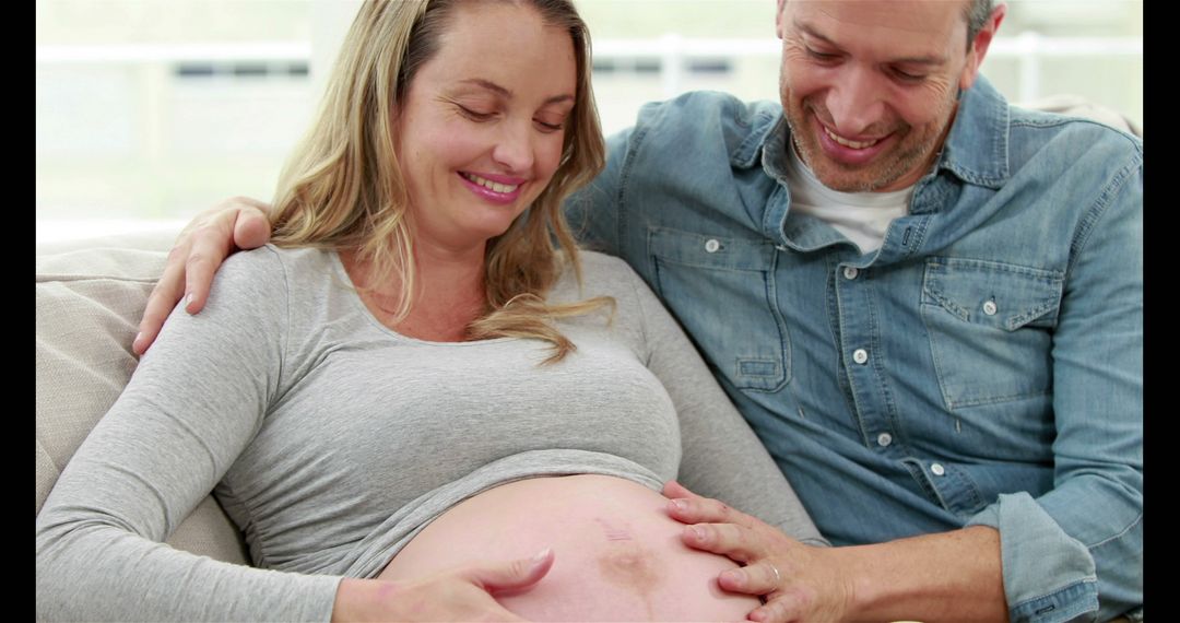 Expectant Couple Enjoying Relaxing Moment on Couch