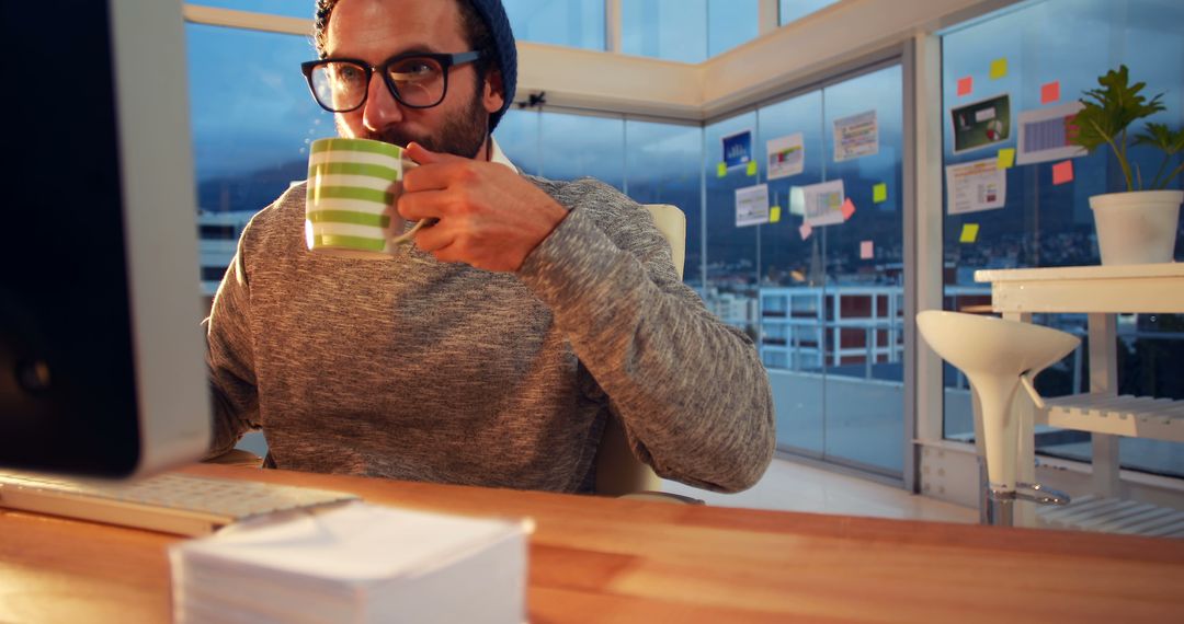 Man Working in Modern Office Drinking Coffee - Free Images, Stock Photos and Pictures on Pikwizard.com