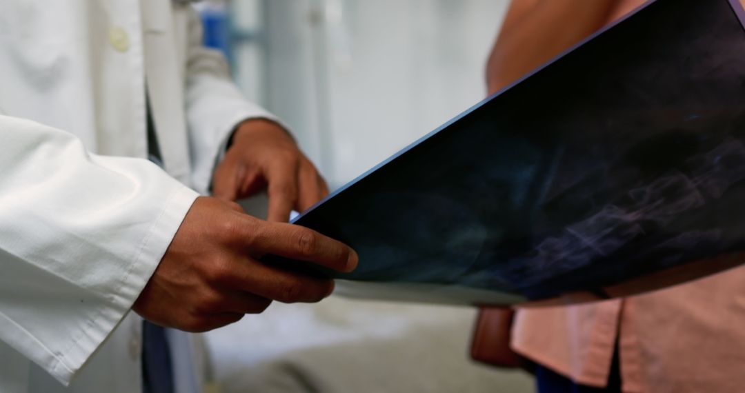 Doctor Examining X-ray Film During Consultation - Free Images, Stock Photos and Pictures on Pikwizard.com