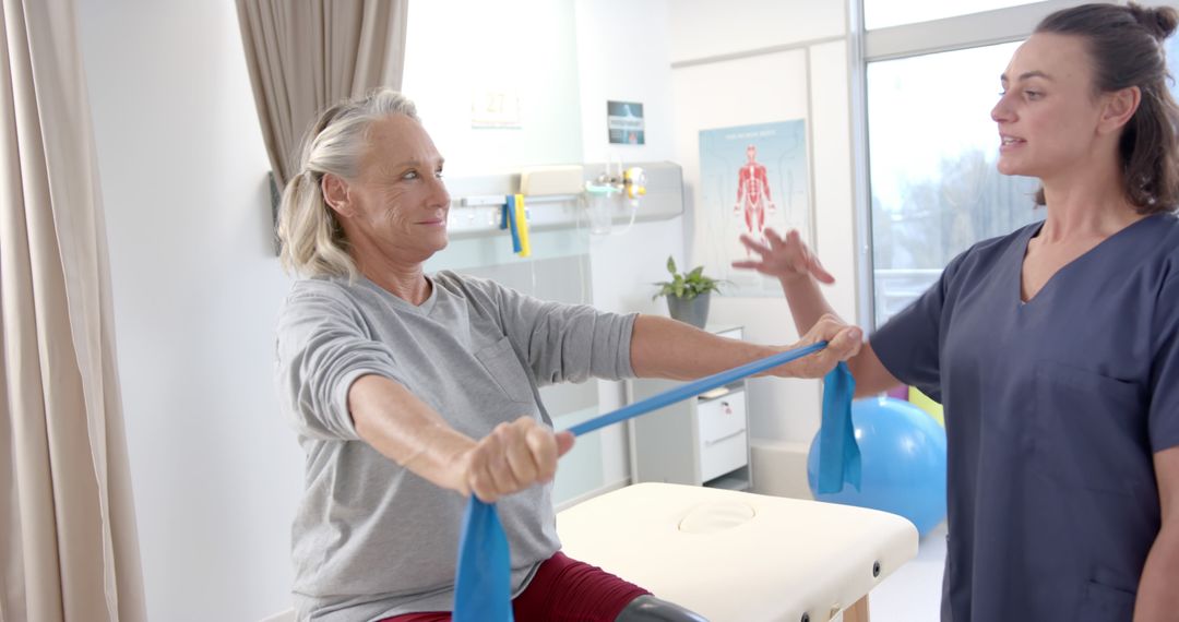 Senior Woman Exercising With Resistance Band Led By Physical Therapist - Free Images, Stock Photos and Pictures on Pikwizard.com