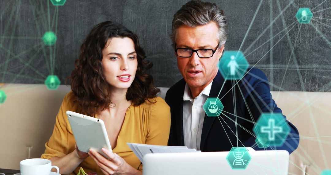 Business Team Analyzing Data on Tablet with Technology Icons