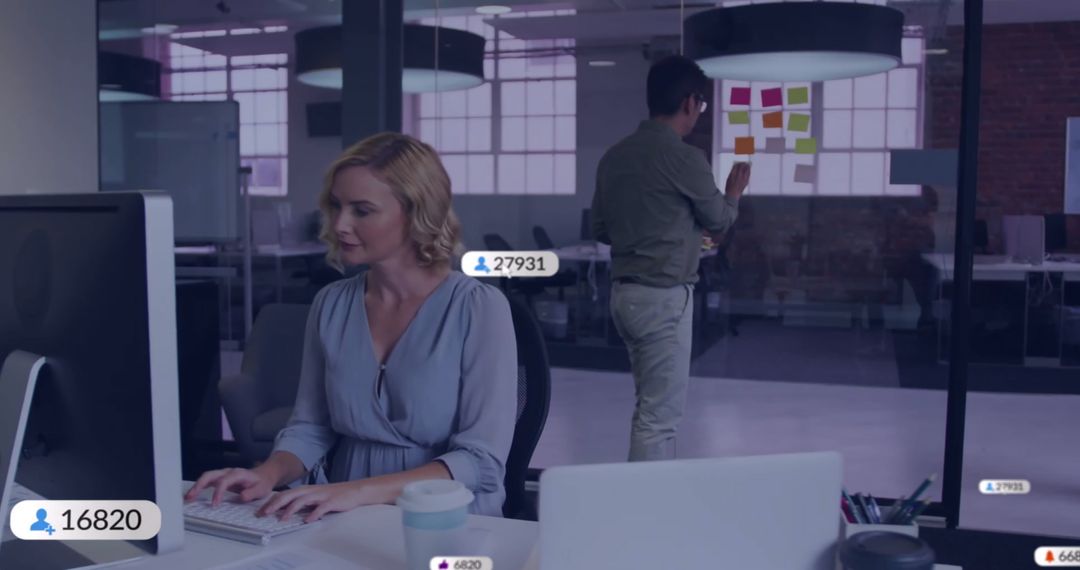 Businesswoman Analyzing Data in Modern Office with Colleague