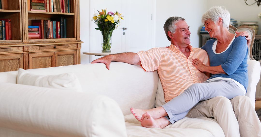 Happy Senior Couple Relaxing on Sofa in Cozy Living Room - Free Images, Stock Photos and Pictures on Pikwizard.com