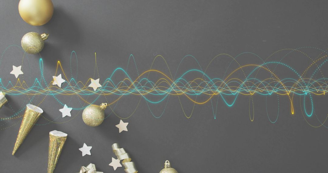 Scattering gold ornaments with teal and gold waveform on gray flat lay