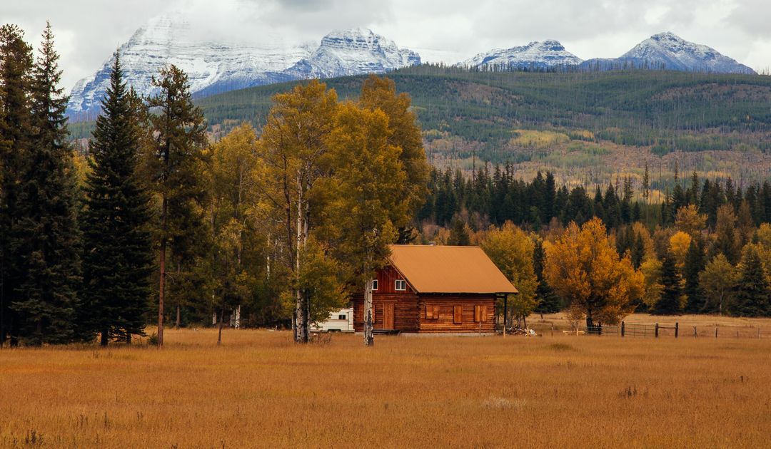 Rustic Cabin in Autumn Forest with Snow-Capped Mountains - Free Images, Stock Photos and Pictures on Pikwizard.com