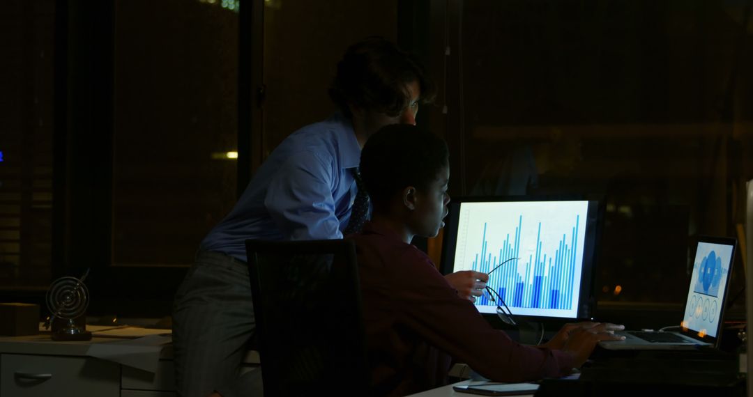 Business Professionals Analyzing Data on Computer at Night in Office - Free Images, Stock Photos and Pictures on Pikwizard.com