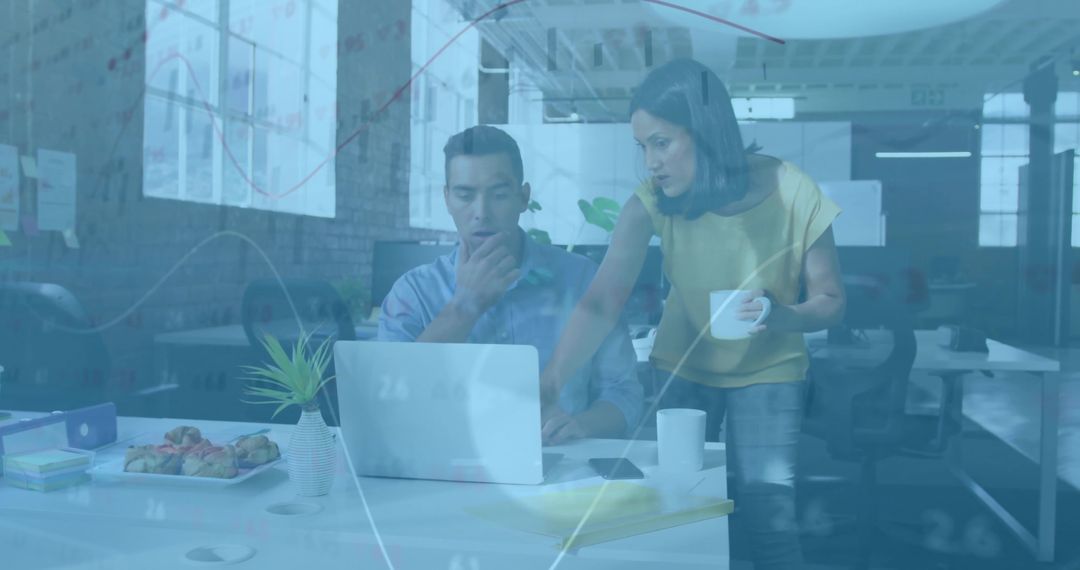 Coworkers Analyzing Financial Charts with Teamwork in Modern Office