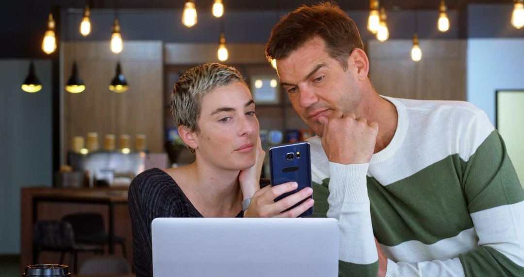 Casual Business Colleagues Collaborating in Modern Cafe