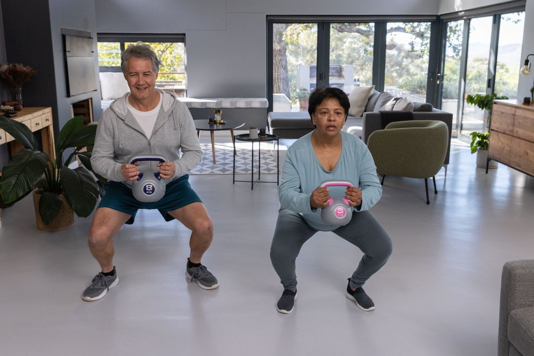 Senior Exercise Partners Using Kettlebells in Modern Living Room