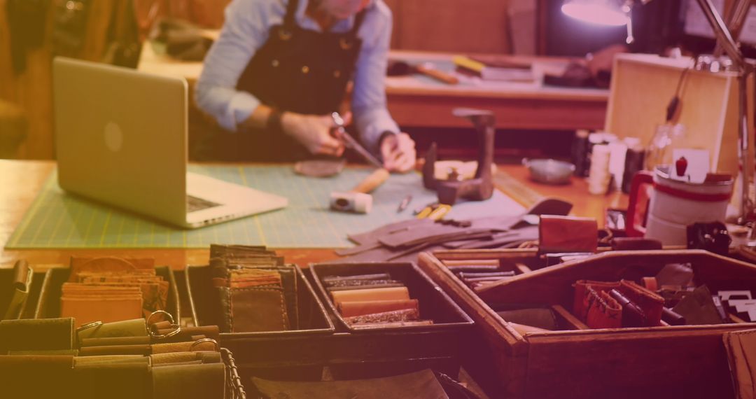 Craftsman Sewing Leather Articles on Workbench in Artisan Workshop