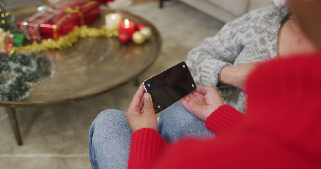 Person Holding Smartphone with Blank Screen During Holiday Celebration - Free Images, Stock Photos and Pictures on Pikwizard.com