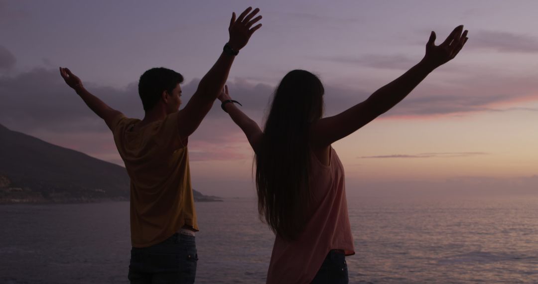 Couple Embracing Sunset by the Sea with Open Arms - Free Images, Stock Photos and Pictures on Pikwizard.com