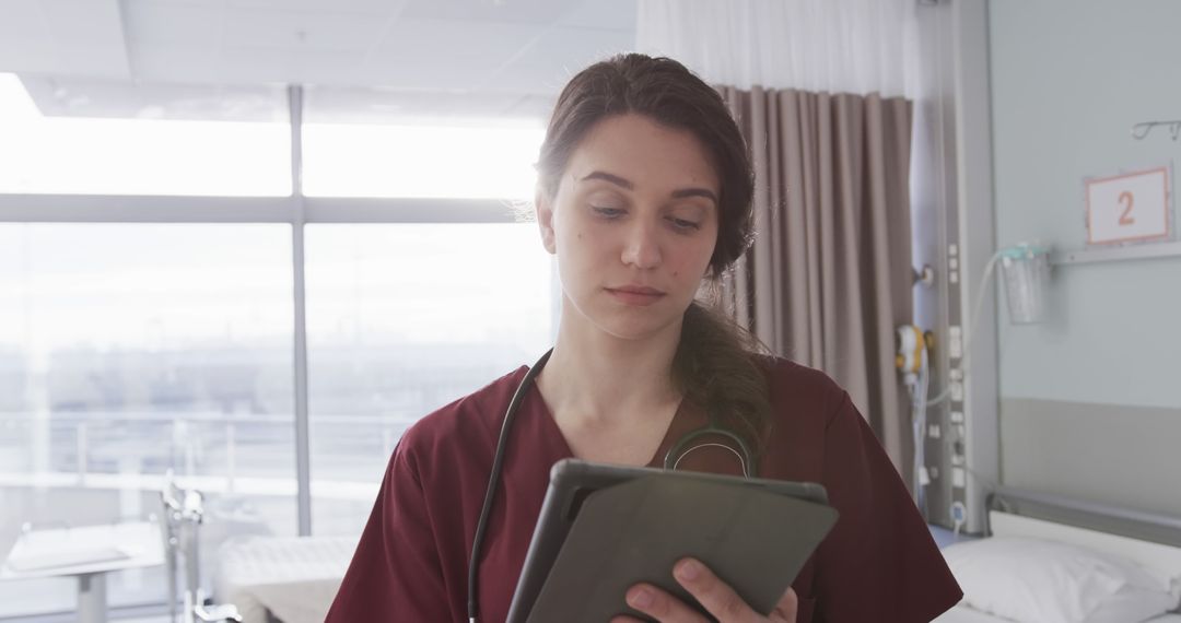 Female Nurse Using Tablet in Hospital Room - Free Images, Stock Photos and Pictures on Pikwizard.com