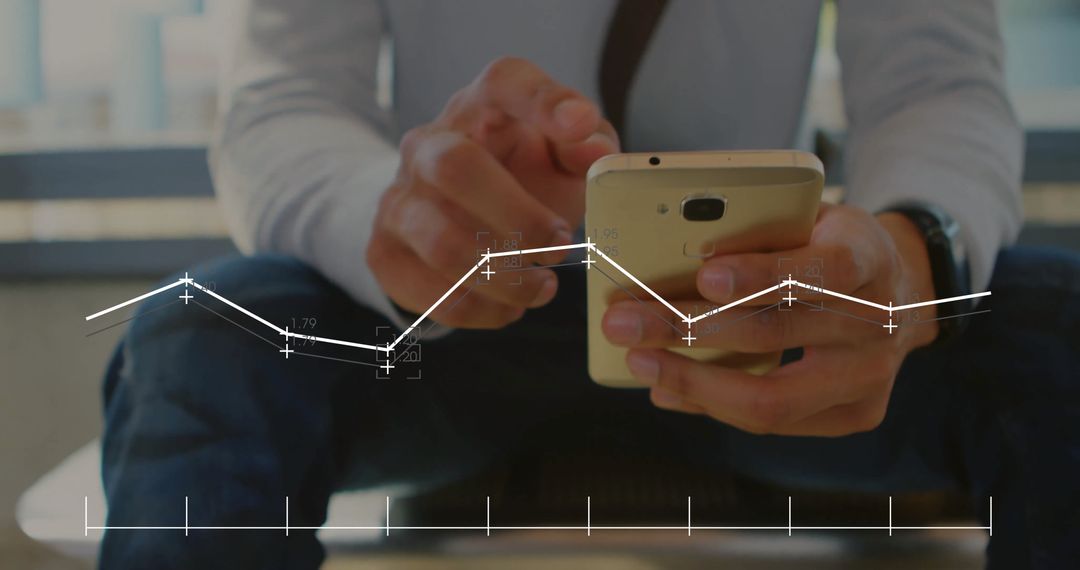 Hand with Smartphone Displaying Financial Data Analytics