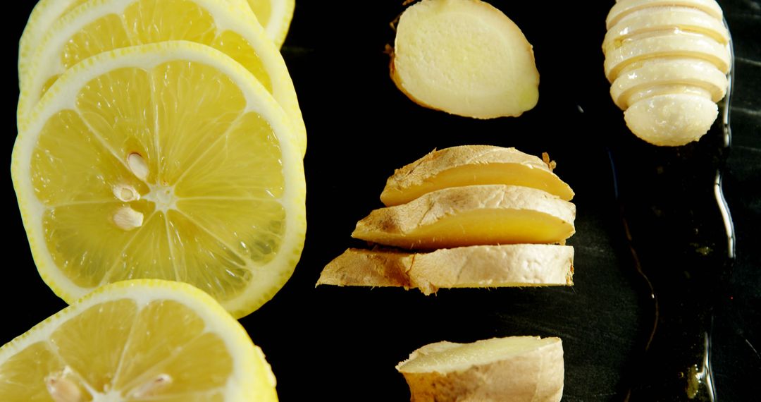 Fresh Sliced Lemon and Ginger with Honey Drizzle on Dark Surface - Free Images, Stock Photos and Pictures on Pikwizard.com