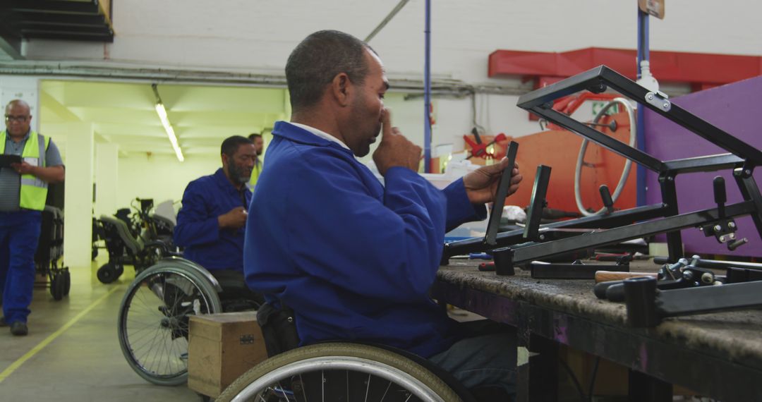 Man in Wheelchair Assembling Equipment in Inclusive Factory - Free Images, Stock Photos and Pictures on Pikwizard.com