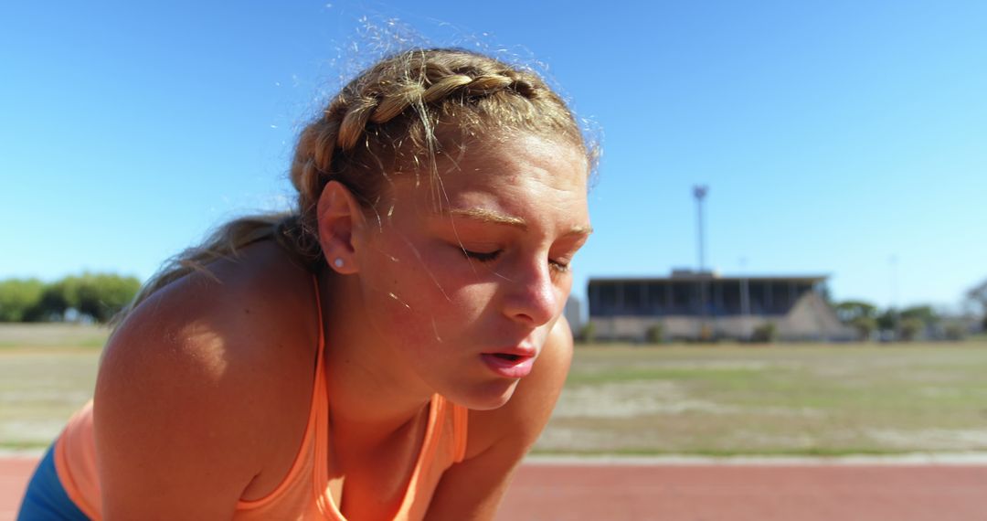 Exhausted Female Runner Resting on Track Outdoors - Free Images, Stock Photos and Pictures on Pikwizard.com