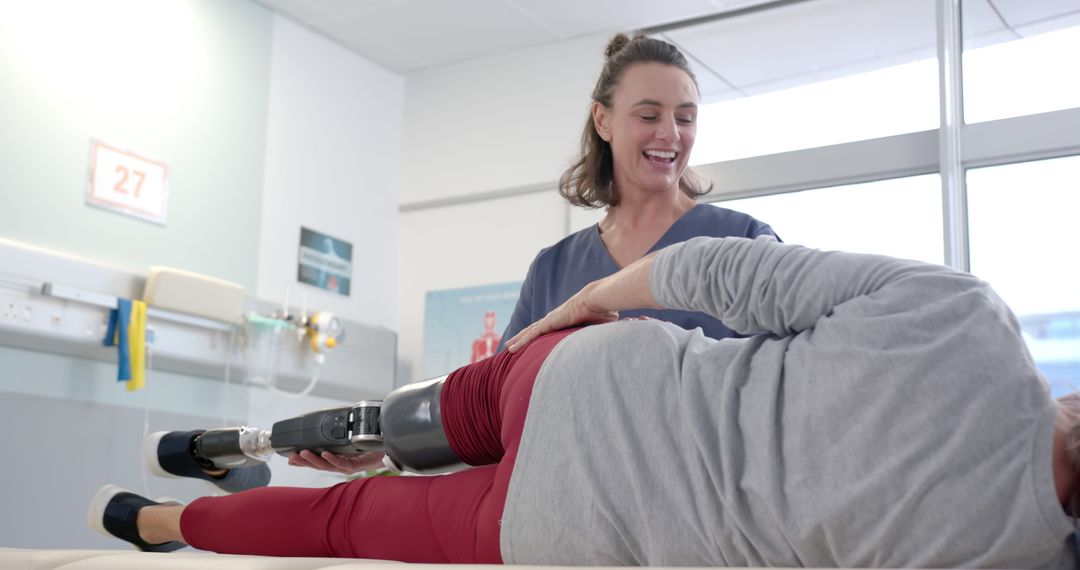 Female Therapist Assisting Patient with Prosthetic Leg During Physical Therapy - Free Images, Stock Photos and Pictures on Pikwizard.com