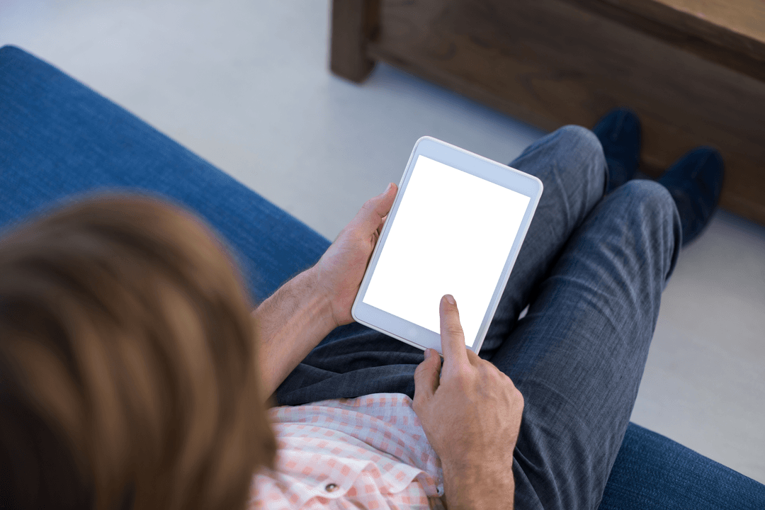 Executive Using Tablet with Blank Transparent Screen Sitting on Sofa