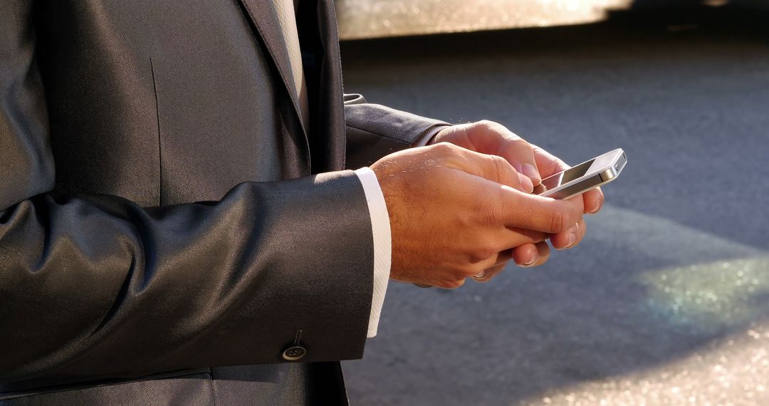 Businessman in Suit Texting on Smartphone Outdoors - Free Images, Stock Photos and Pictures on Pikwizard.com