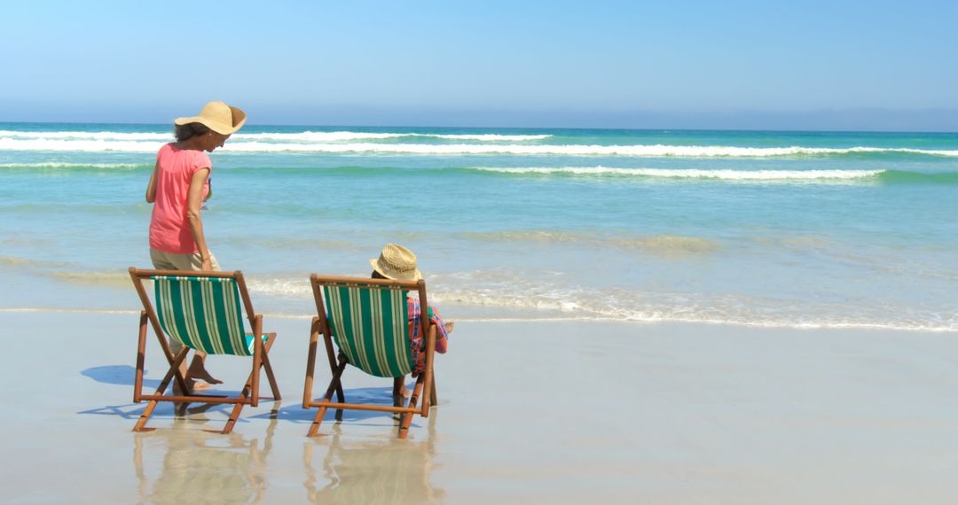 Senior Couple Relaxing in Deckchairs on Sunny Beach Day