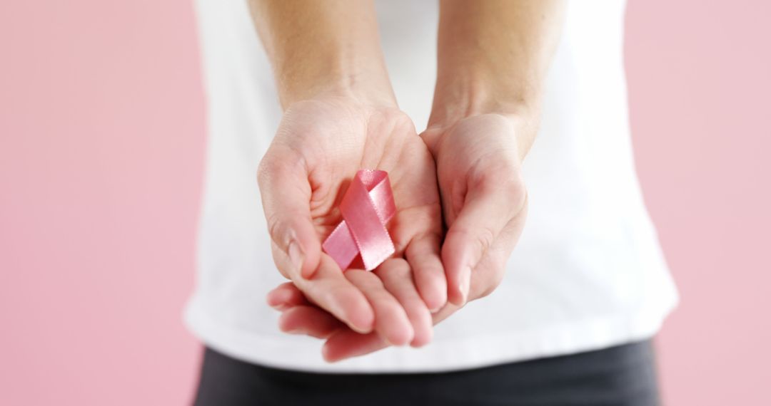 Person Holding Pink Ribbon for Cancer Awareness - Free Images, Stock Photos and Pictures on Pikwizard.com