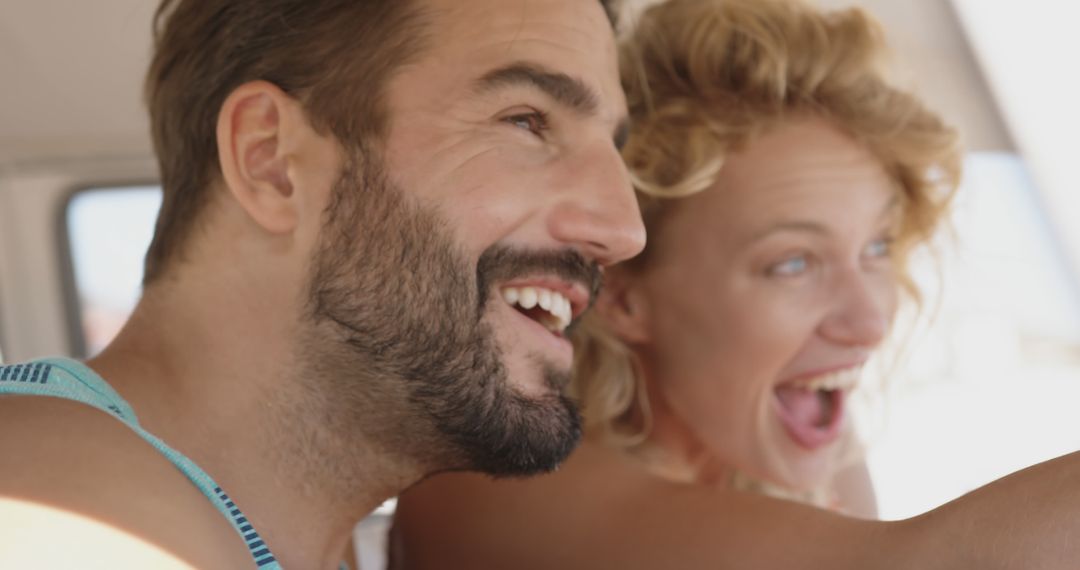 Joyful Couple Enjoying Beach Road Trip in Campervan