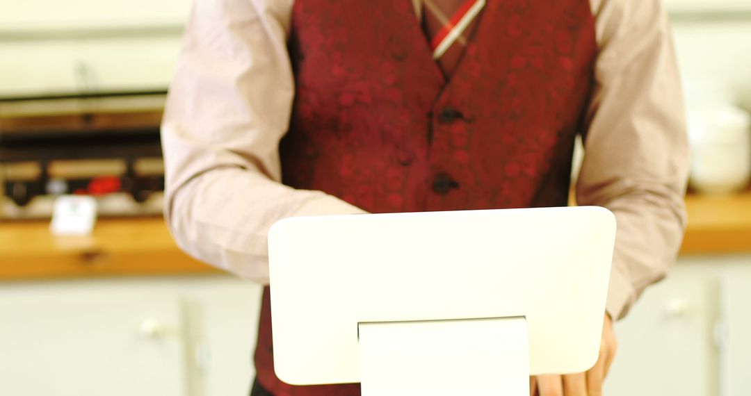 Caucasian Barista Operating a Tablet in Modern Cafe
