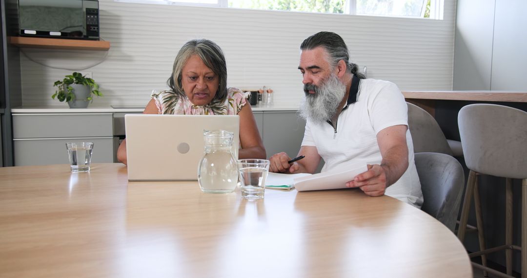 Senior Couple Collaborating with Technology at Home