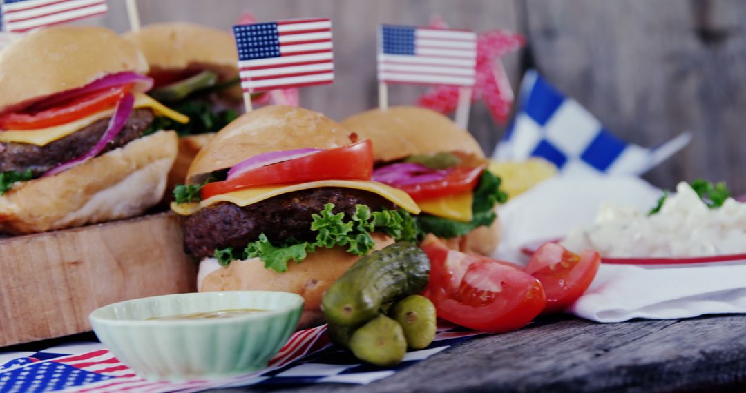 Delicious American cheeseburgers with flag decorations and pickles - Free Images, Stock Photos and Pictures on Pikwizard.com